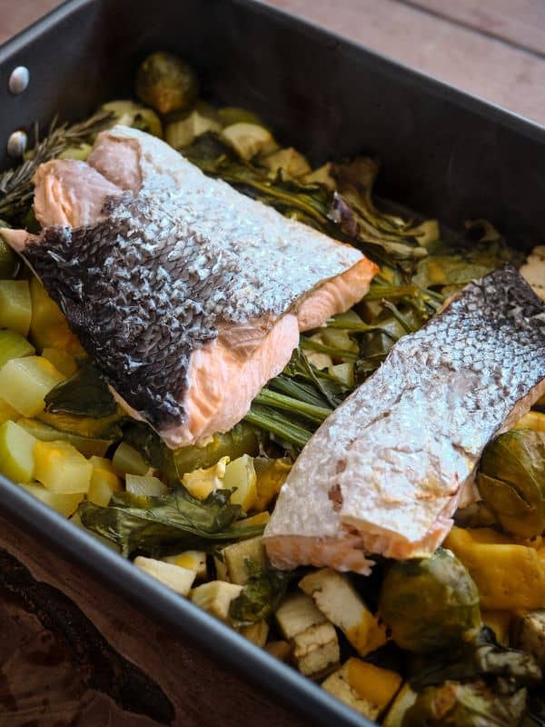 spanish salmon recipe in a tray with vegetables