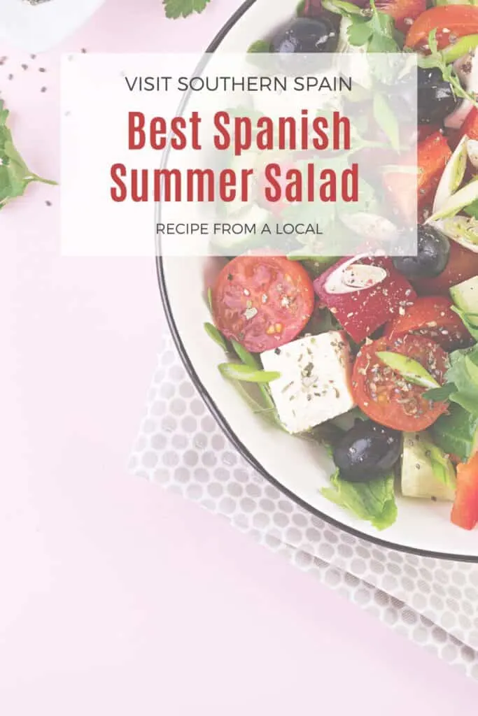 a pin with spanish summer salad with tomatoes, olives and feta.