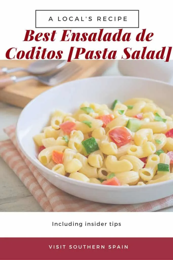 a pin with a bowl of ensalada de coditos, spanish pasta salad with vegetables and ham.