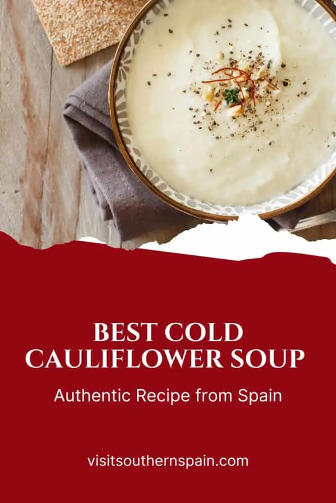 a pin with Cold Cauliflower Soup in a bowl on a rustic table.