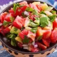 a closeup of with a bowl of ensalada de aguacate,spanish avocado salad with tomatoes