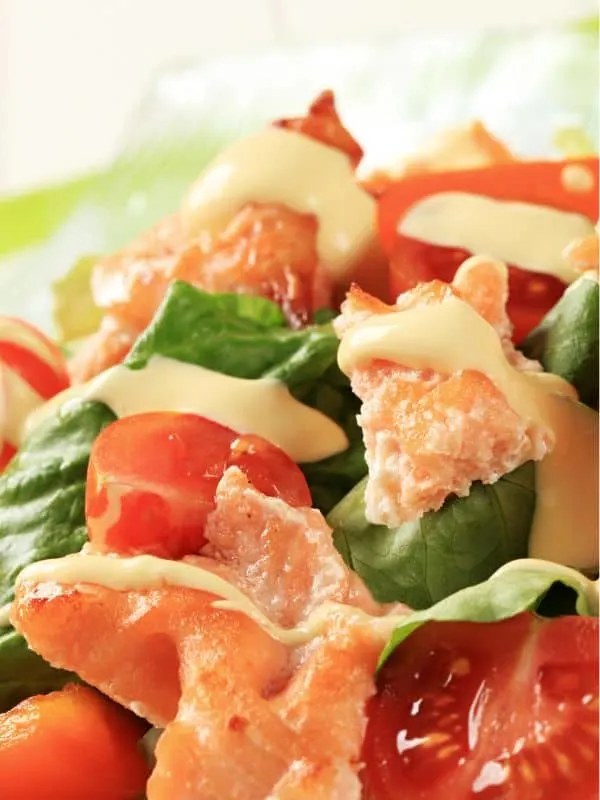 closeup of a ensalada de salmon, spanish salmon salad with tomatoes and dressing.