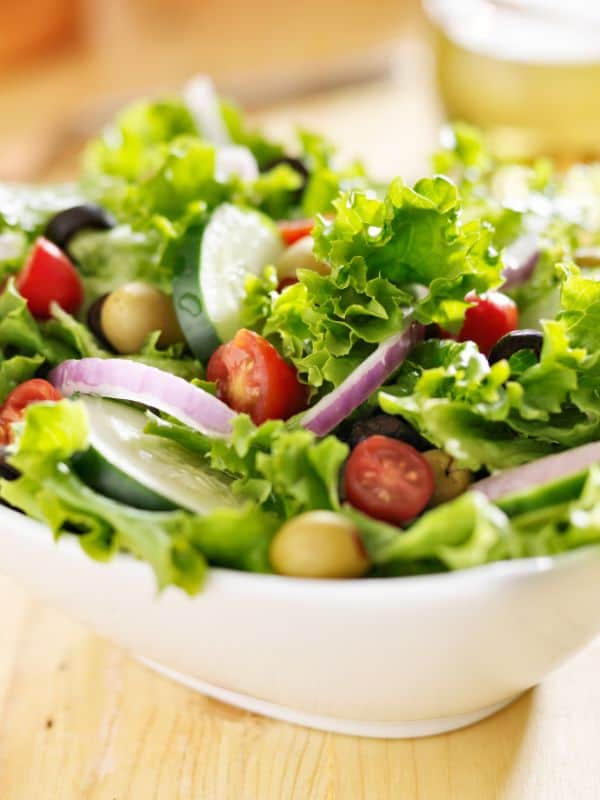closeup of a spanish green salad with lettuce and onion