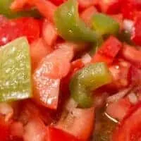closeup of a trampo salad with tomatoes, peppers and onion