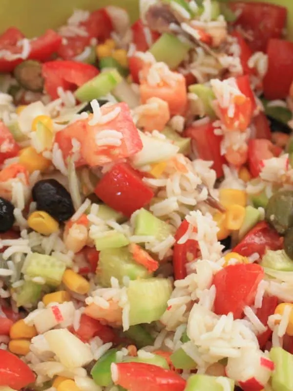 closeup with spanish rice salad with tomatoes, olives and vegetables