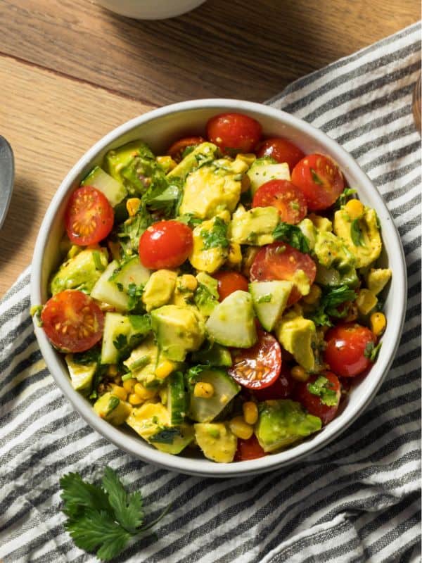 ensalada de aguacate in a bowl with tomatoes