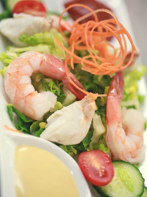 ensalada de gambas with tomatoes, cucumber and shrimp on lettuce