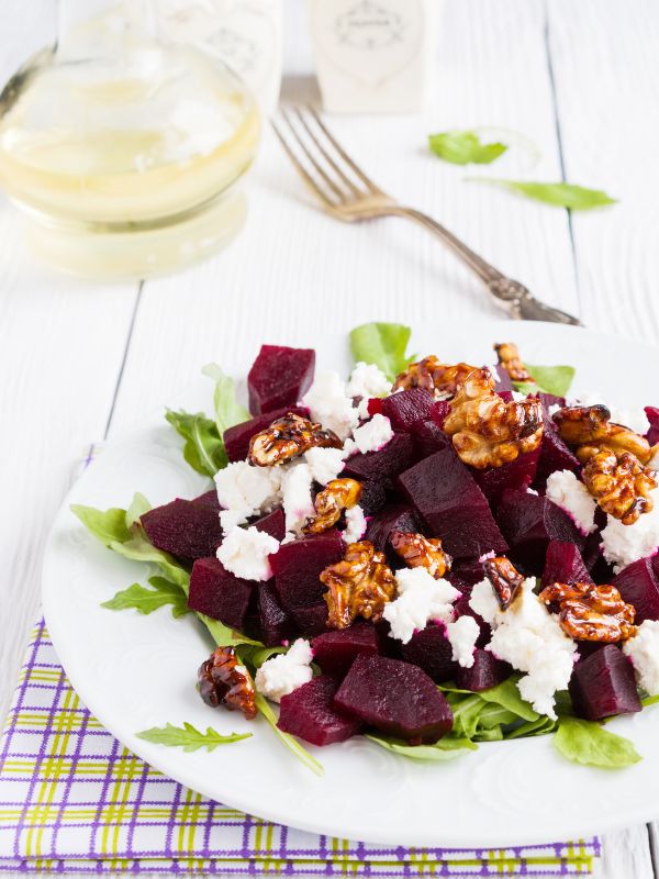 ensalada de remolacha, spanish beets salad with walnuts, feta and lettuce on a plate.