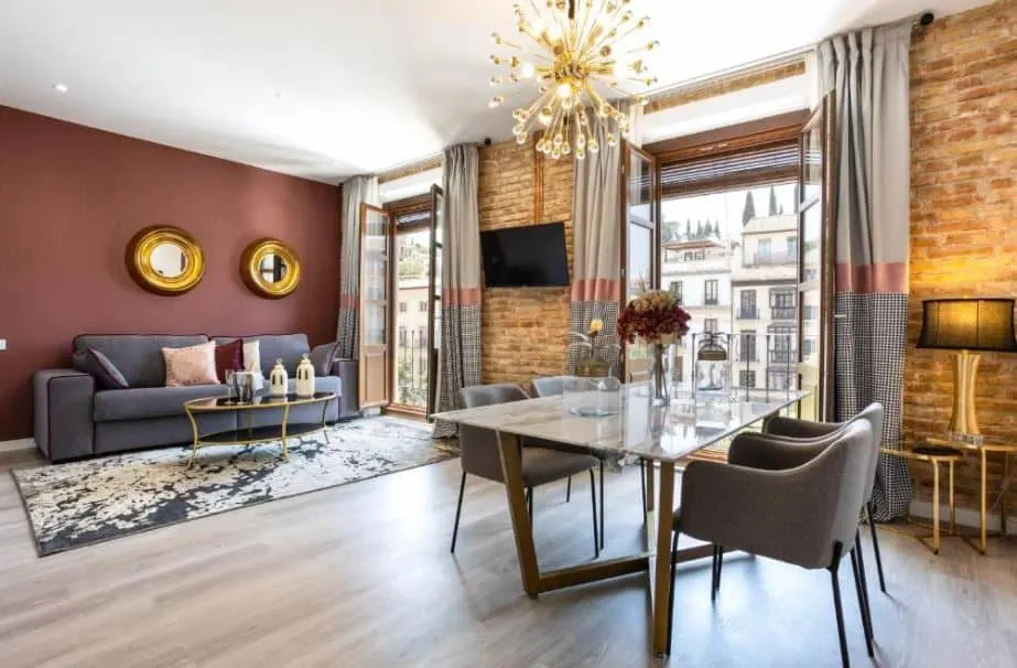 interior of a luxurious room with sofa and city view at BiBo Suites Plaza Nueva, Granada