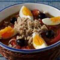 murcia salad with tuna, eggs and tomatoes in a bowl.
