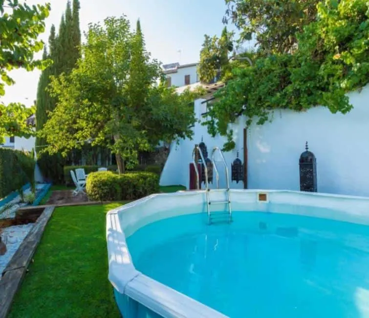 outside pool in a beautiful garden at Carmen Vistas de la Alhambra in Granada
