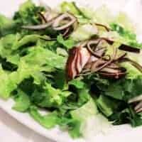 spanish green salad with onion on a plate