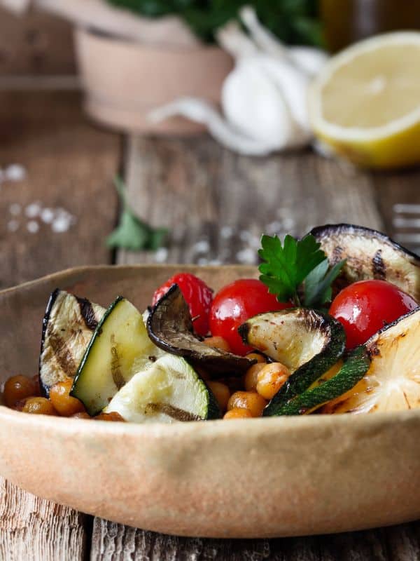 spanish grilled veggie salad in a wooden bowl