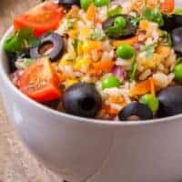 spanish rice salad with tomatoes, olives and vegetables