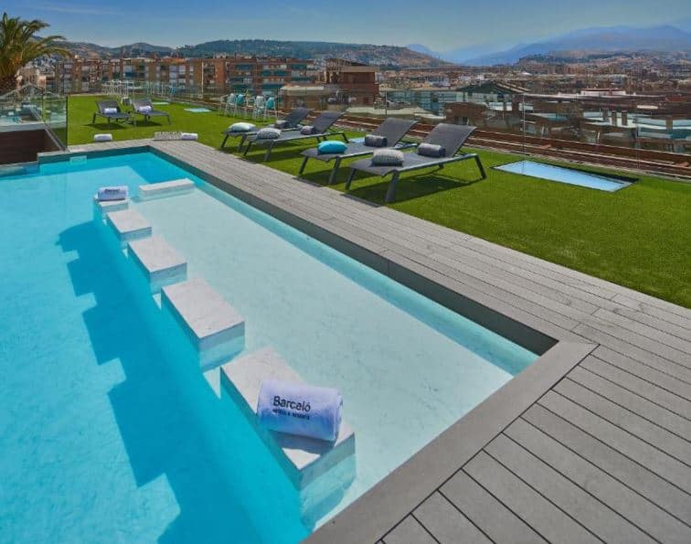 the outdoor pool at Barcelo Granada Congress with views of the mountains and Granada city