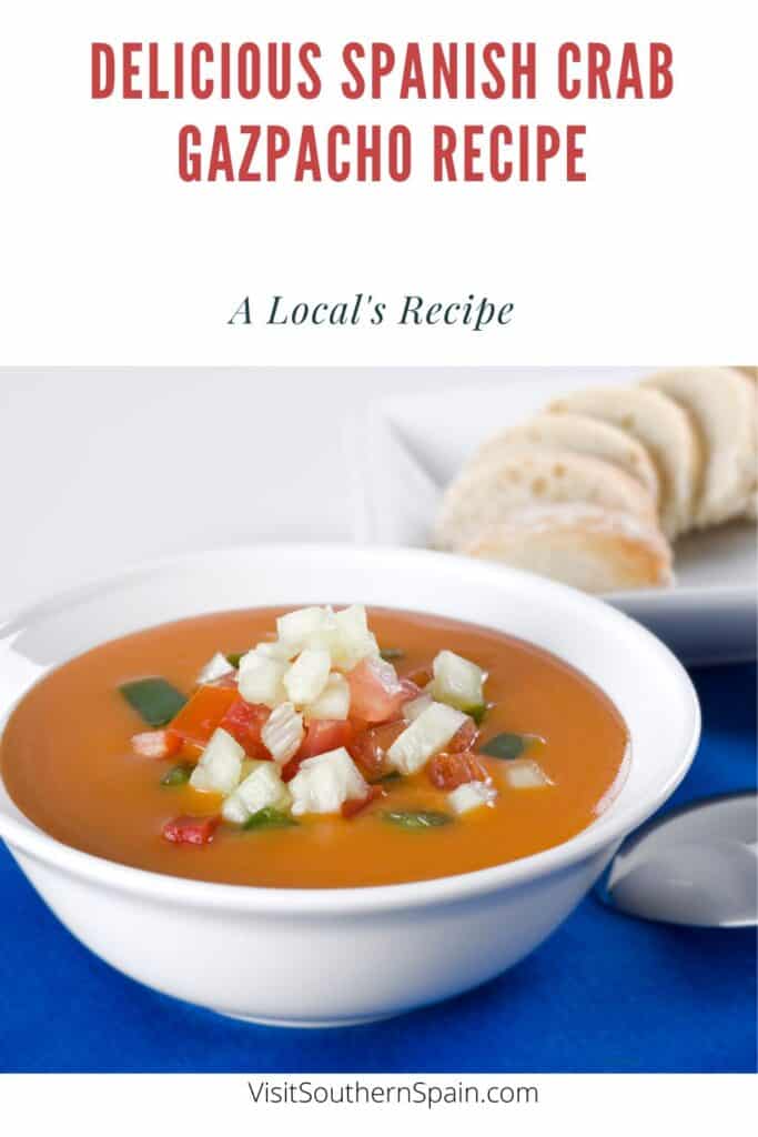 a pin with a bowl of crab gazpacho served with bread.