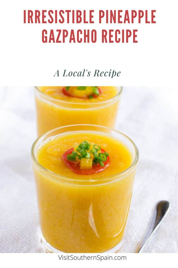 a pin with pineapple gazpacho in 2 glasses decorated with fresh fruit.