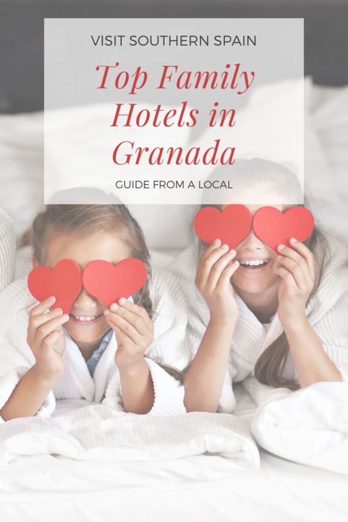a pin with 2 kids holding paper hearts on their eyes on a bed at one of the best family hotels in Granada
