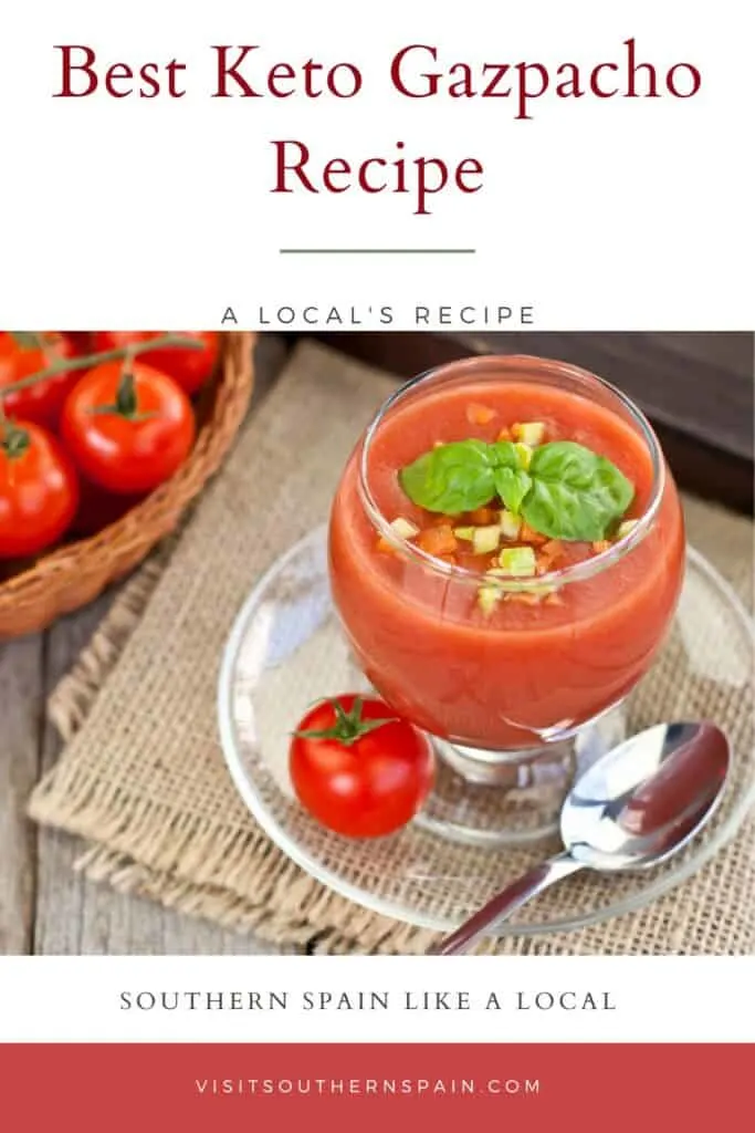 a pin with a keto gazpacho served in a glass on a rustic table.