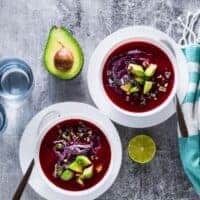 2 bowl of Beetroot Gazpacho decorated with avocado and red cabbage