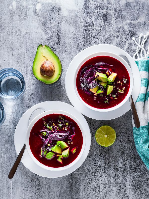 2 bowl of Beetroot Gazpacho decorated with avocado and red cabbage - Best Beetroot Gazpacho Recipe from Spain