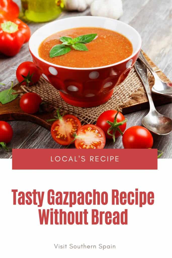 a pin with gazpacho recipe without bread in a red bowl with tomatoes next to it.