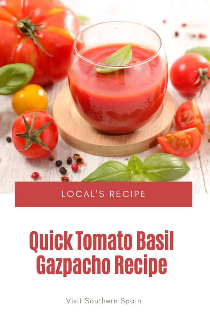 a pin with a glass of tomato basil gazpacho with tomatoes and basil next to it.
