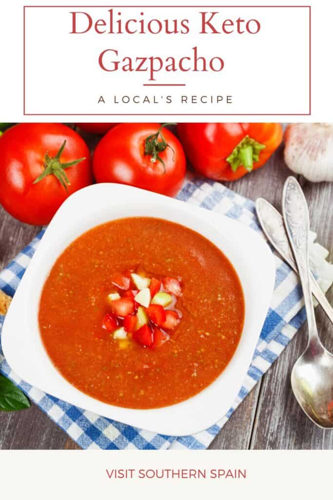 a pin with keto gazpacho in a bowl with tomatoes next to it,