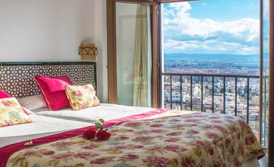 cozy bedroom with balcony overlooking Granada city, at Hotel Mirador Arabeluj