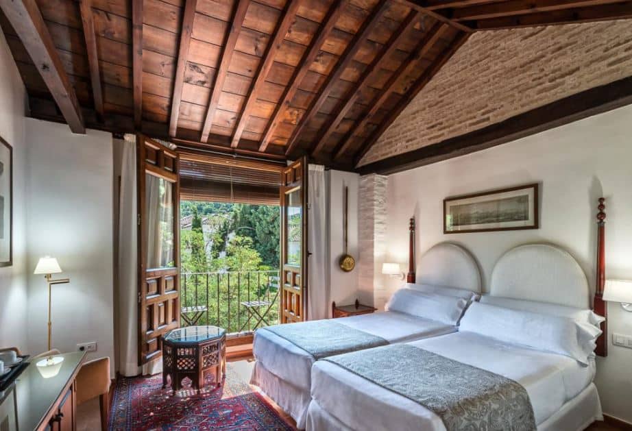 interior of a bedroom with small balcony at Hotel Casa Morisca, Granada