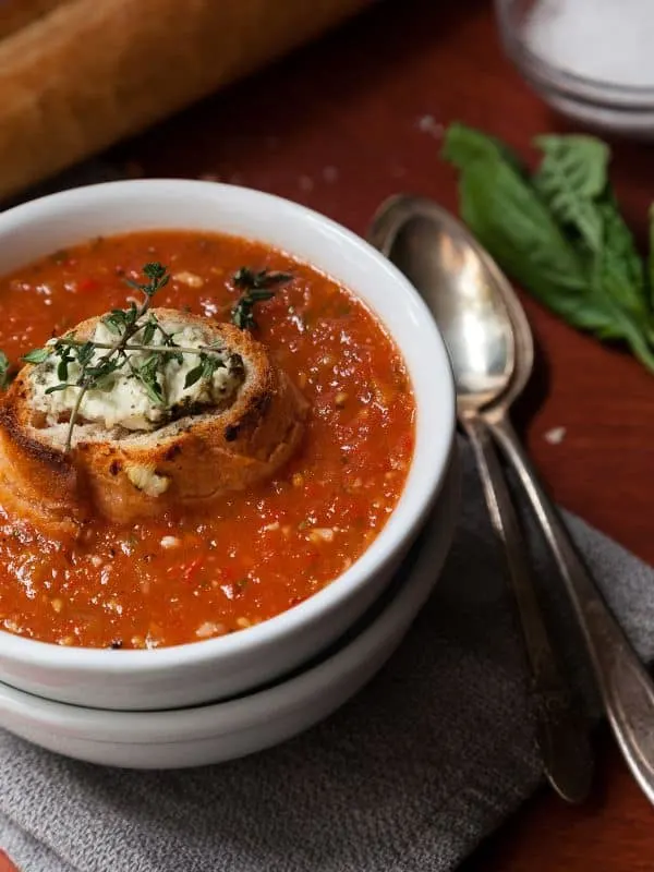 roasted tomato gazpacho served in a bowl with a toast on top