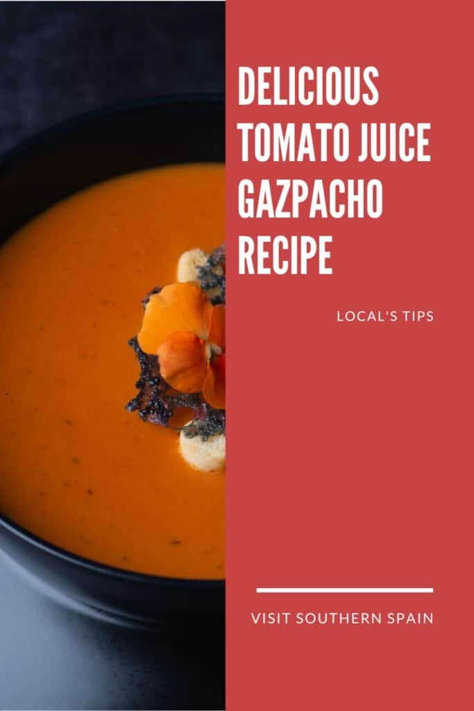 a pin with tomato juice gazpacho in a black bowl.
