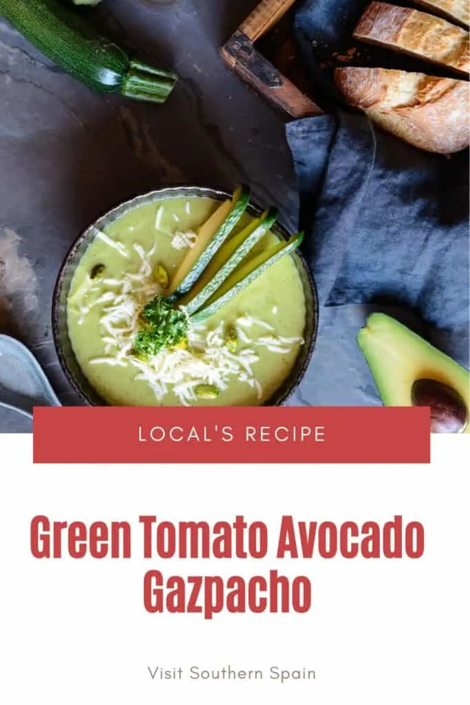 a pin with Green Tomato Avocado Gazpacho in a bowl on a kitchen towel.