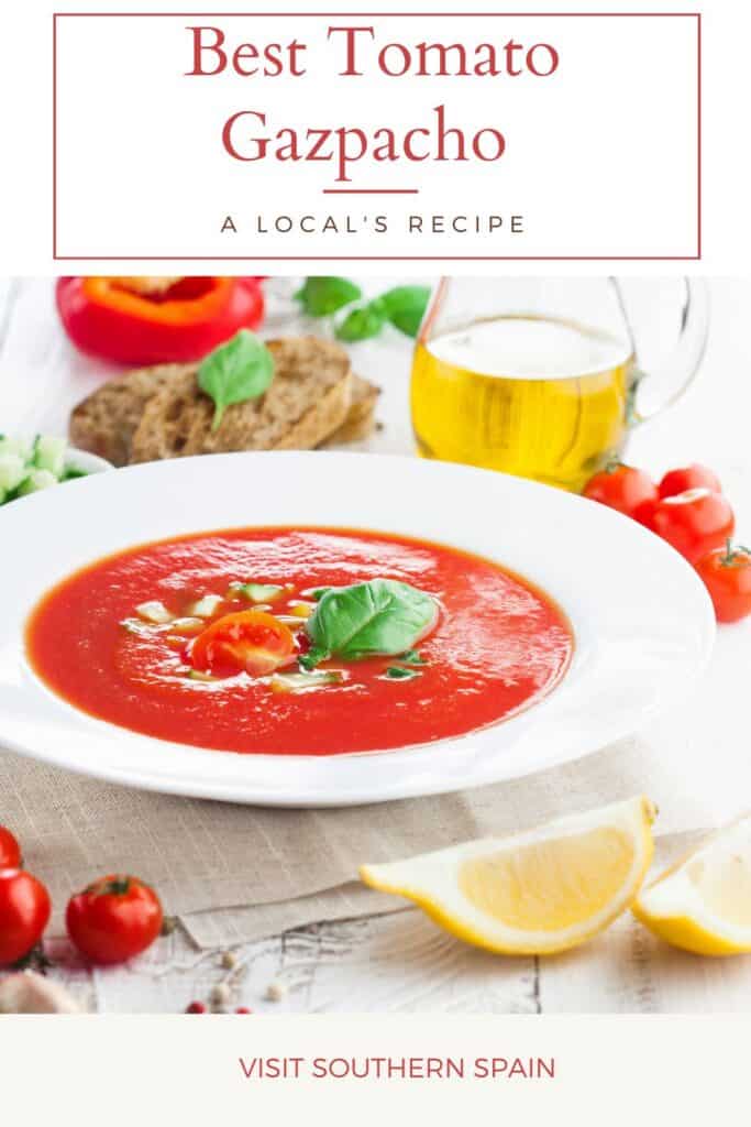 a pin with the best tomato gazpacho in a bowl with tomatoes, olive oil and bread surrounding it.