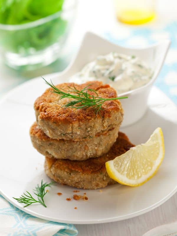 3 patties on top of each other served with lemon and sauce using the mackerel Patty recipe