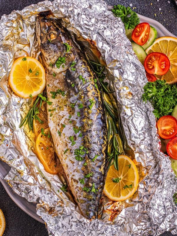 Spanish Baked Mackerel Recipe
 with lemon slices, tomatoes and herbs