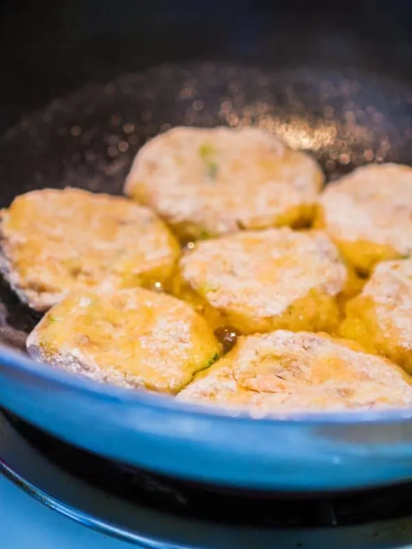 Mackerel Patty recipe being fried in a blue pan.