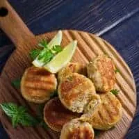 Mackerel patties on wooden board served with lemon made with the easy Mackerel patties Recipe
