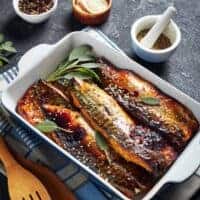 peppered Mackerel Recipe in a clay try with seasoning next to it.