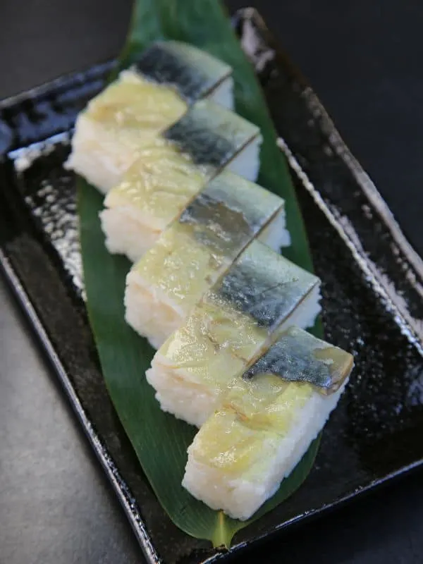 Spanish Mackerel sashimi on a black plate