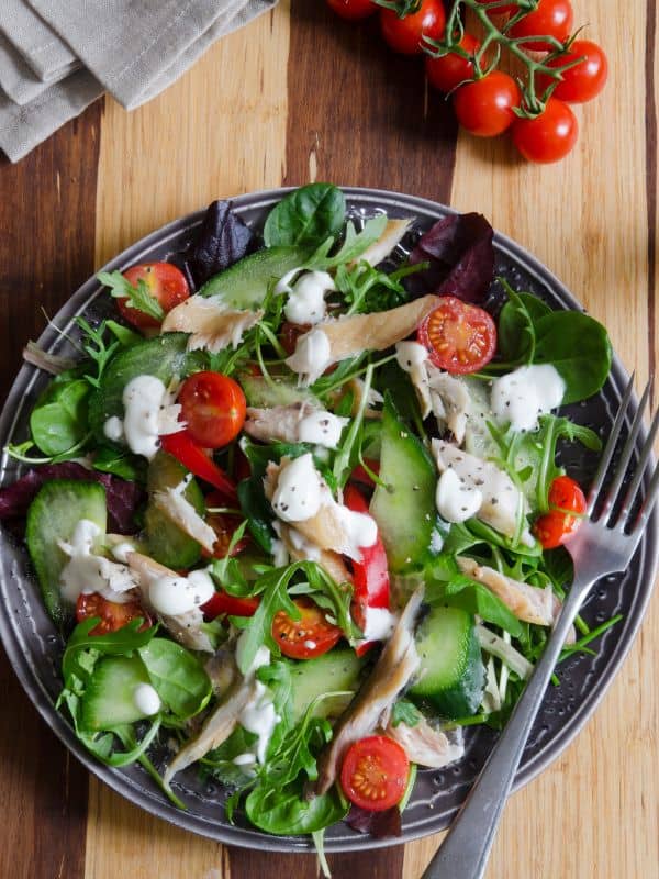 a bowl of salad made with the smoked mackerel salad recipe with tomatoes