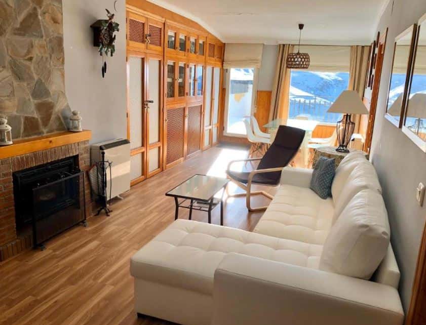 room with sofa, fire place and balcony at LUXURY GINEBRA apartments in Sierra Nevada