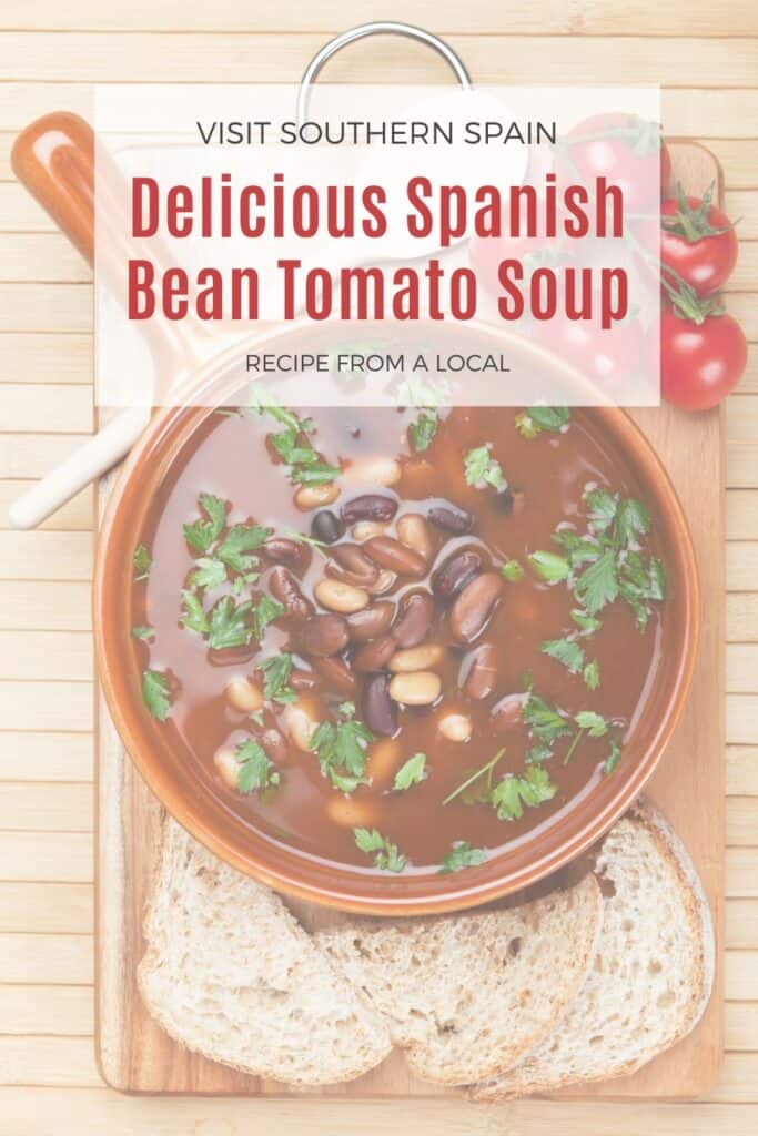 a pin with Cozy Spanish Bean Tomato Soup in a clay bowl.