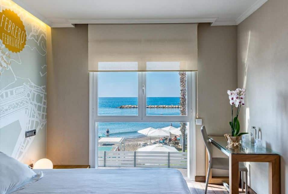 bedroom overlooking the beach and sea at one of the beachfront hotels in malaga