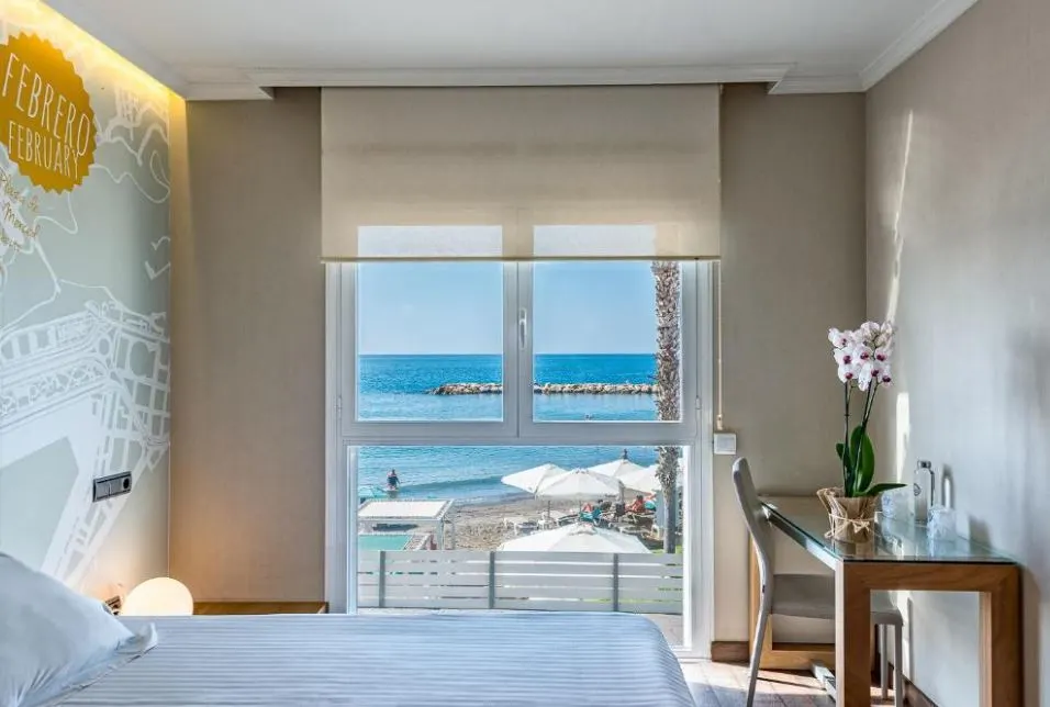 bedroom overlooking the beach and sea at one of the 3-star hotels in malaga