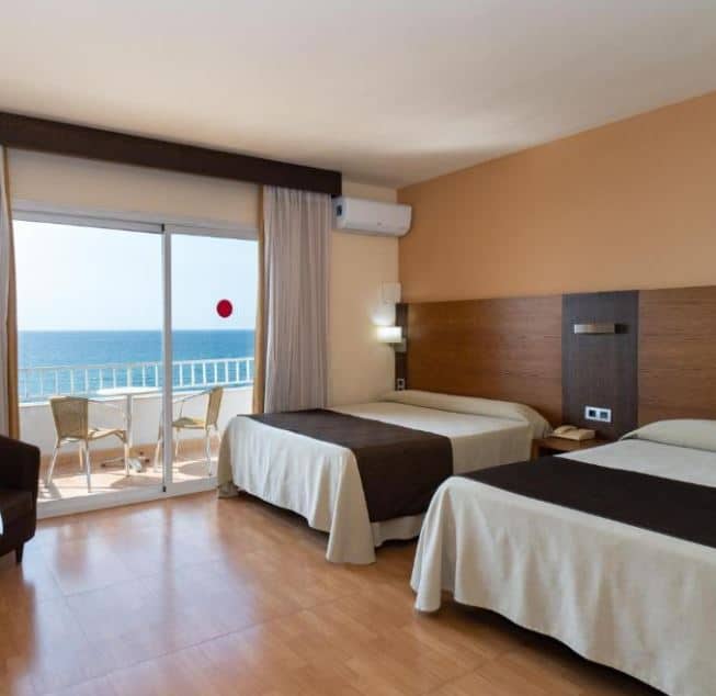 bedroom with separate beds at one of the best beachfront hotels in malaga
