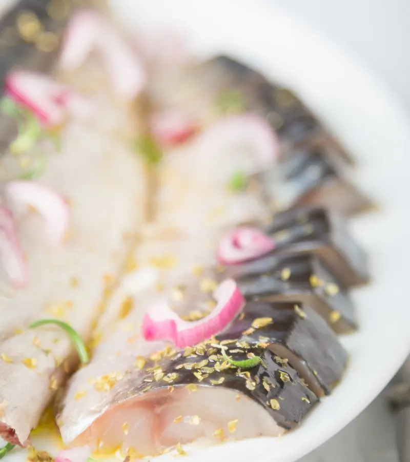 closeup of steamed mackerel recipe on a plate.
