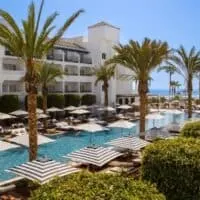 pool area with palm trees overlooking the sea at METT Hotel & Beach Resort Marbella Estepona, best malaga beach hotels