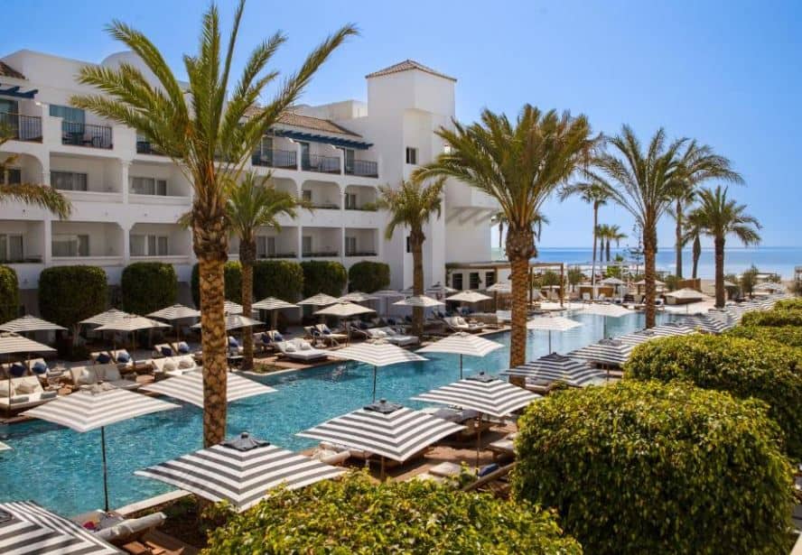 pool area with palm trees overlooking the sea at METT Hotel & Beach Resort Marbella Estepona, resorts near Malaga