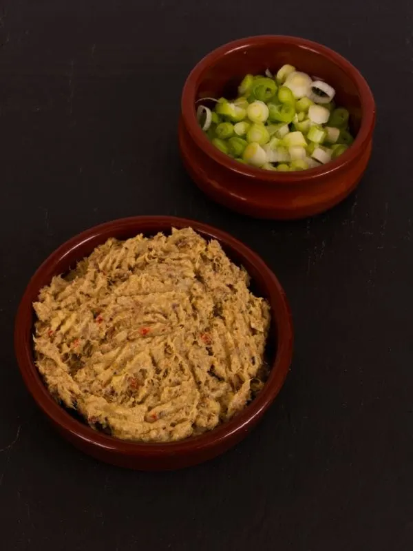 fresh mackerel pate recipe in a clay bowl served with spring onion made with the smoked mackerel recipe
